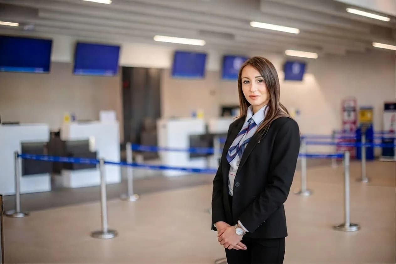 A Worldwide Greeter representative waiting in an airport terminal