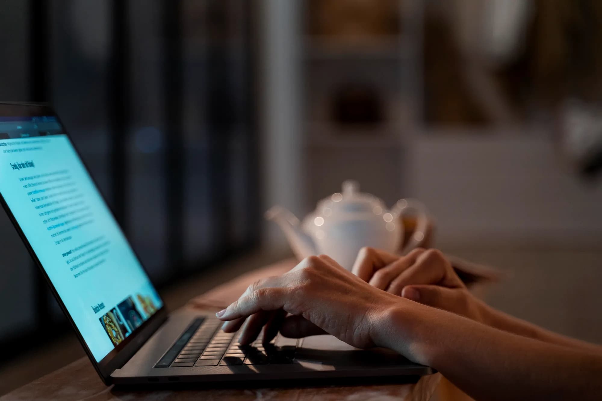 A traveler reading on a laptop at a quiet desk