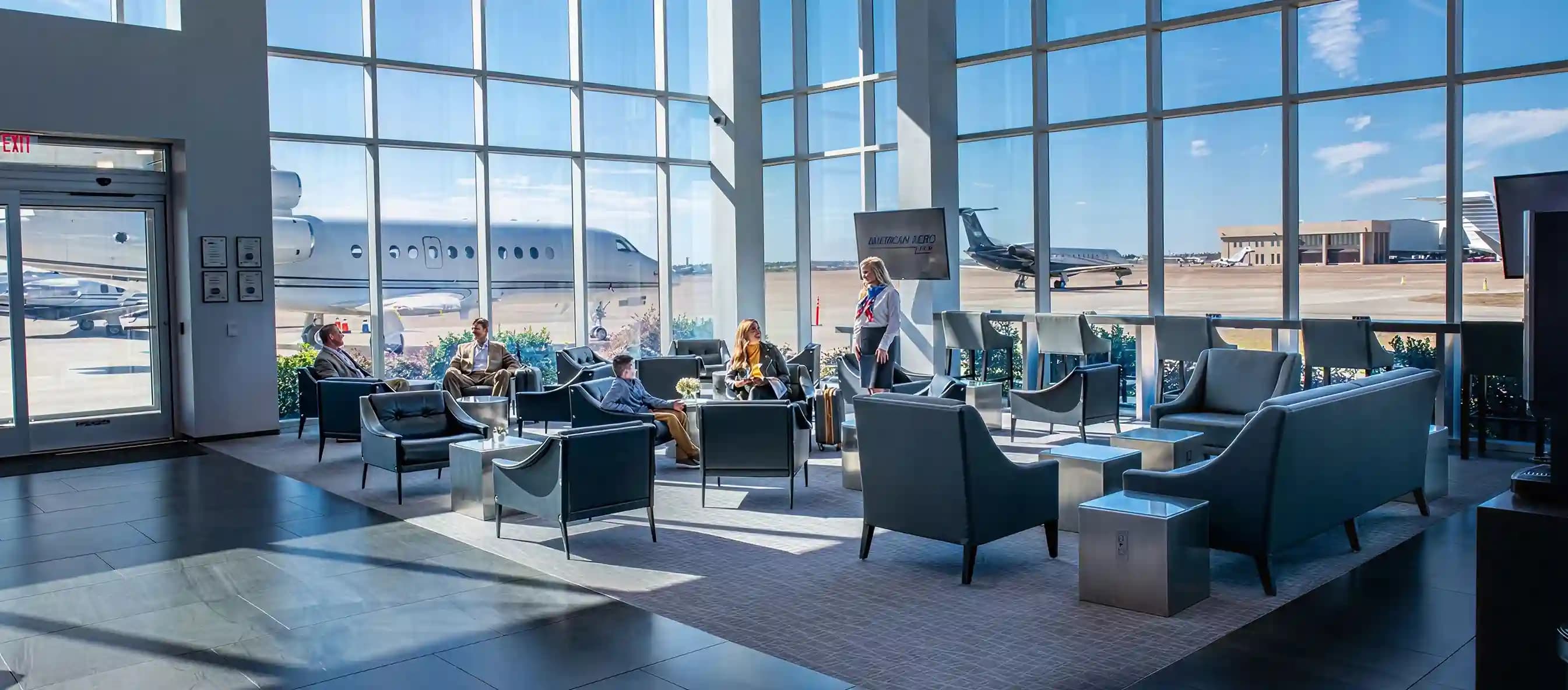 Travelers relaxing in comfortable seating inside an airport lounge