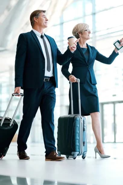 Executive travelers assisted through an airport terminal
