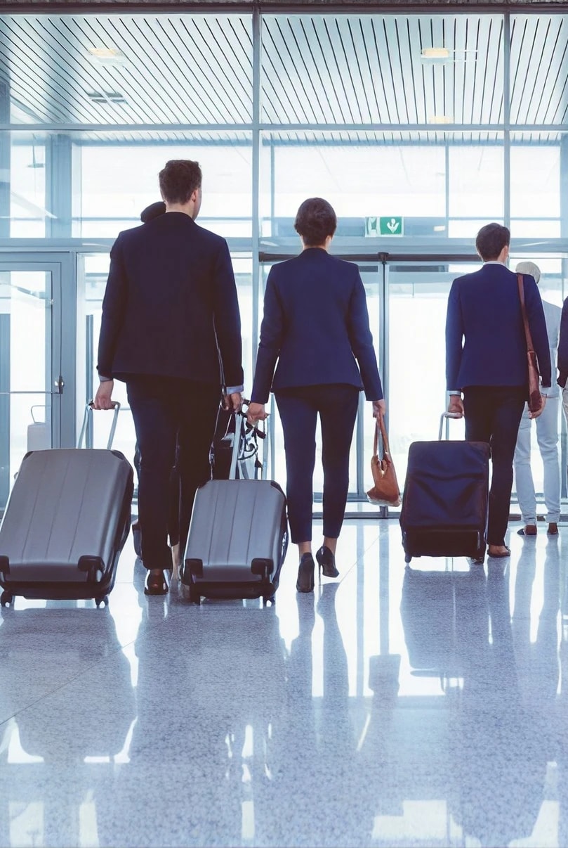 Travelers heading toward a departure gate with their bags