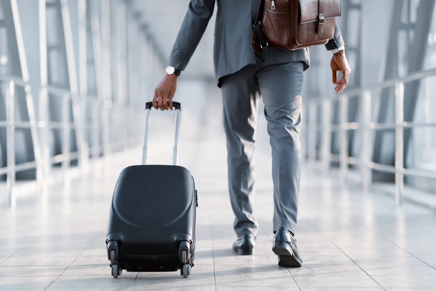 A business traveler crossing the terminal with a suitcase