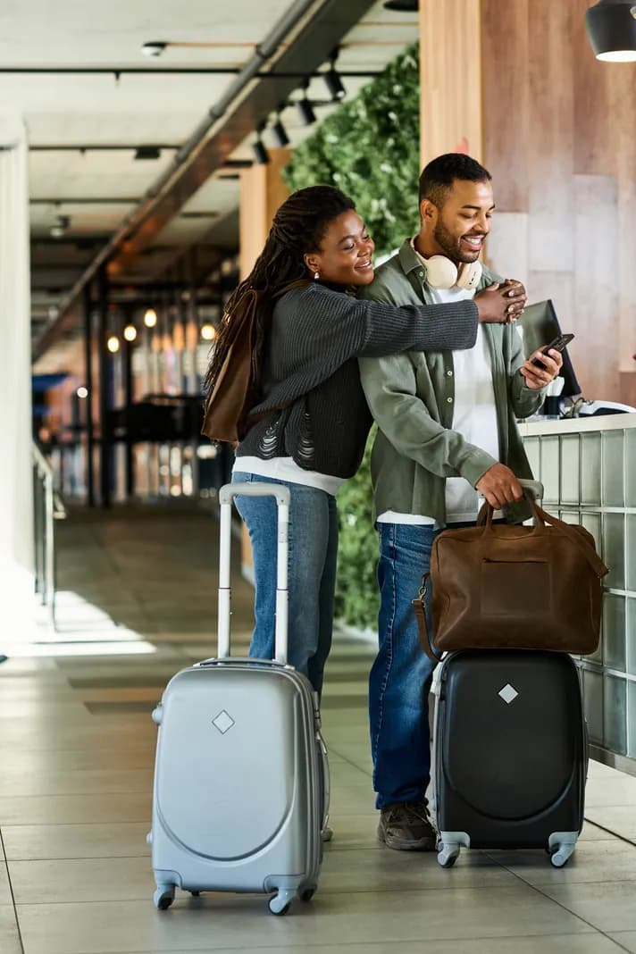A couple checking in with their suitcases